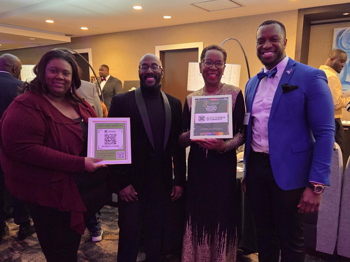 people pose standing for a photo